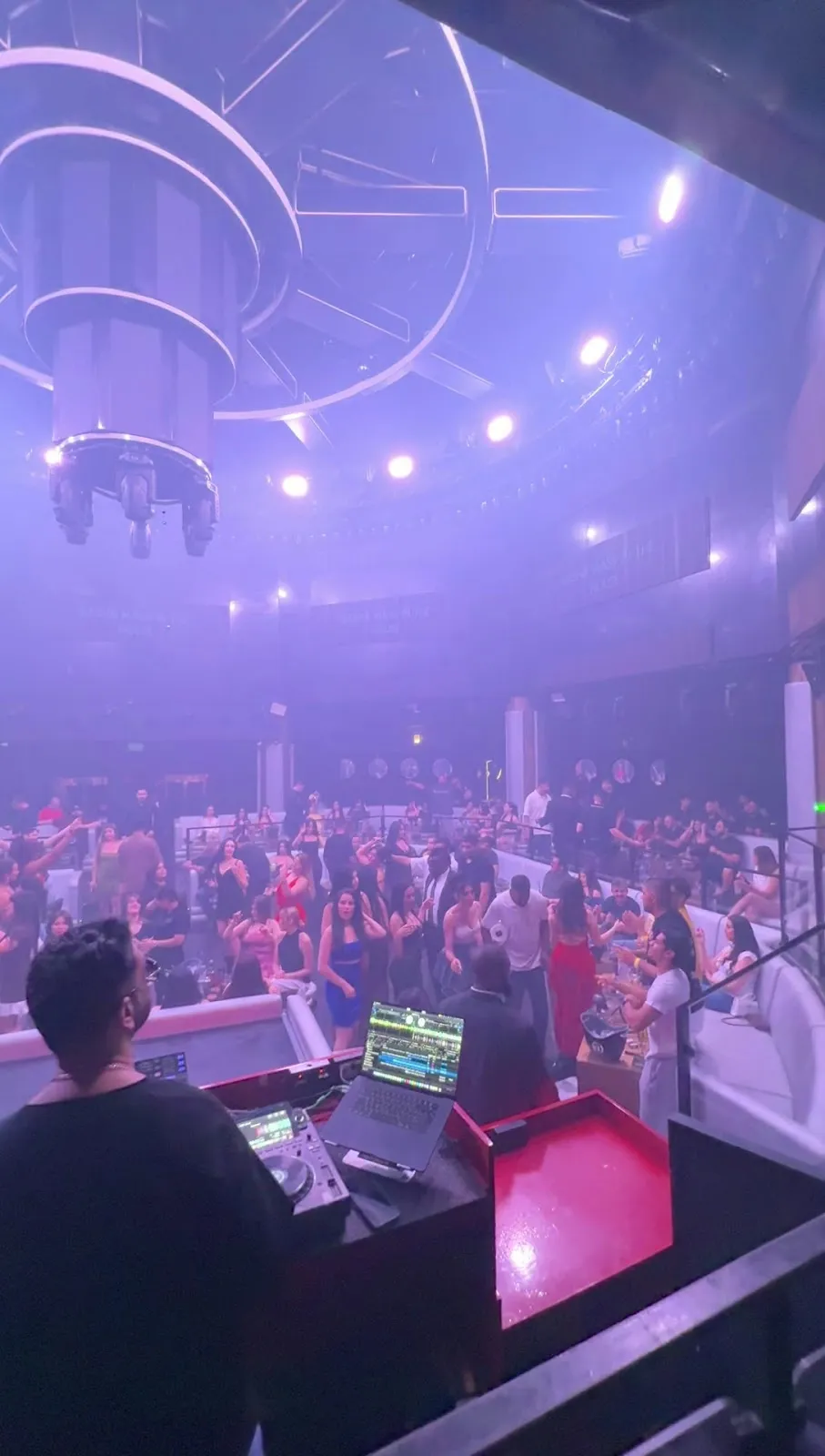 Raised DJ booth looking out over the dance floor and lounge booths